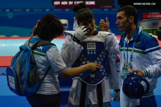 Abdullaeva Umida (C) of Uzbekistan reacts after women +63kg final of taekwondo at the Nanjing 2014 Youth Olympic Games in Nanjing, east China's Jiangsu Province, Aug. 21, 2014.