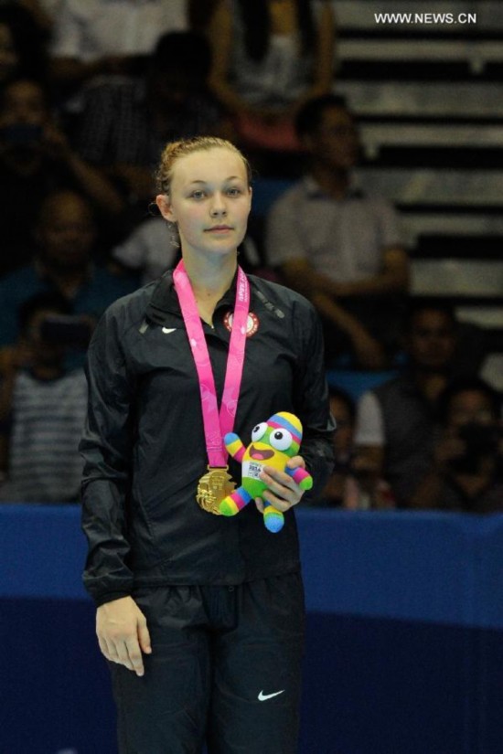 Gold medalist Kendall Yount poses during the awarding ceremony of the Women +63kg final of Taekwondo at the Nanjing 2014 Youth Olympic Games in Nanjing, capital of east China's Jiangsu Province, on August 21, 2014. 