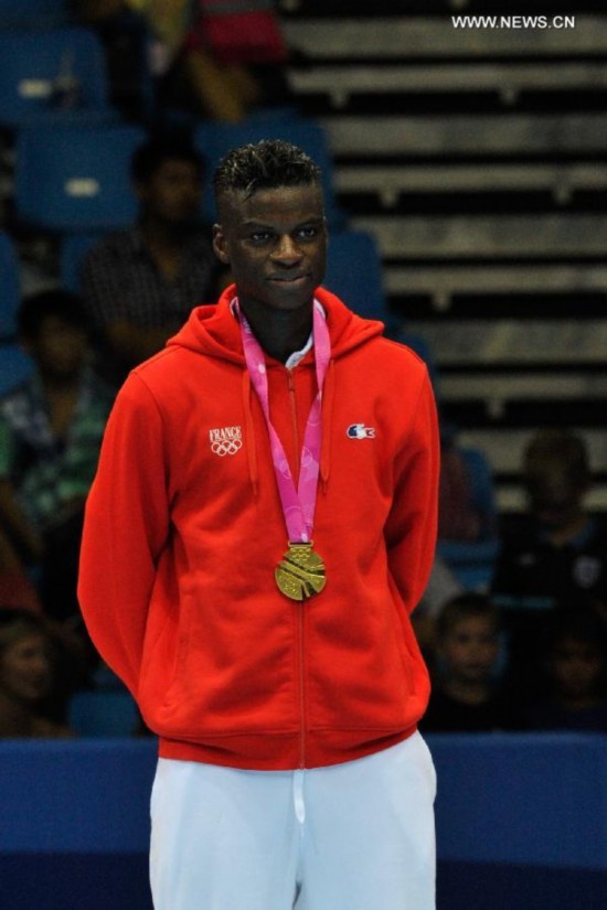 Gold medalist Yoann Miangue(L) of France poses on the podium during the awarding ceremony of men+73kg final of Taekwondo event of Nanjing 2014 Youth Olympic Games in Nanjing, capital of east China's Jiangsu Province, on Aug. 21, 2014. 