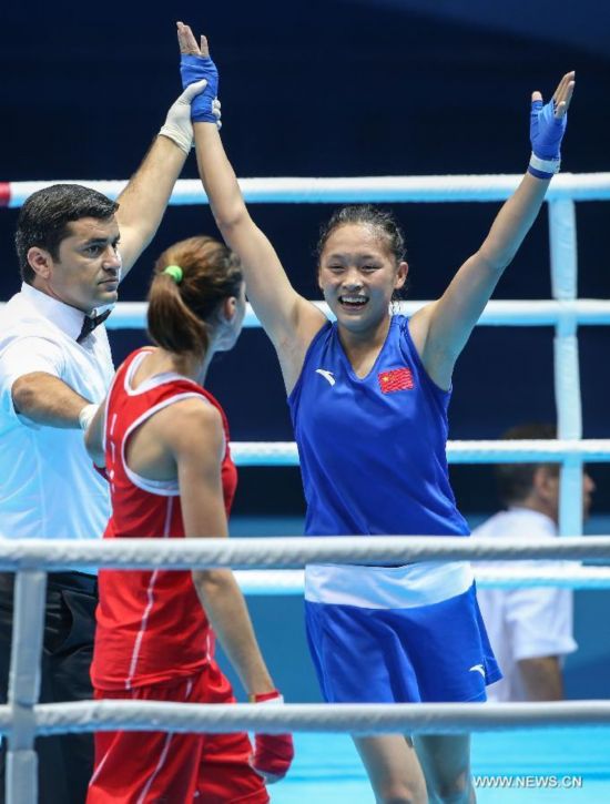 The referee annouces Chang Yuan of China wins the Women's Fly (48-51kg) Boxing final match at Nanjing 2014 Youth Olympic Games in Nanjing, capital of east China's Jiangsu Province, on Aug. 26, 2014. Chang Yuan of China won the gold medal.