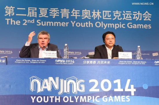 Thomas Bach (L), the president of International Olympic Committee, speaks during the International Olympic Committee press conference on the last day of Nanjing 2014 Youth Olympic Games in Nanjing, capital of east China's Jiangsu Province, on August 28, 2014.