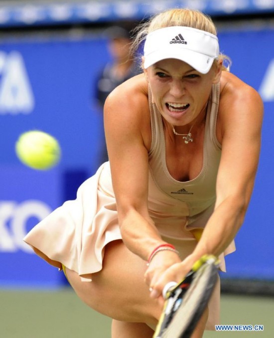 Caroline Wozniacki of Denmark hits a return against Carla Suarez Navarro of Spain during the third round match at the Toray Pan Pacific Open tournament in Tokyo, Japan, Sept. 19, 2014.