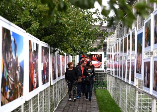 People visit the 14th Pingyao International Photography Festival in Pingyao, north China's Shanxi Province, Sept. 19, 2014. 