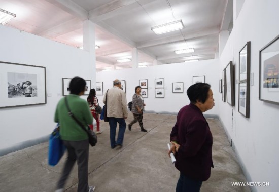 People visit the 14th Pingyao International Photography Festival in Pingyao, north China's Shanxi Province, Sept. 19, 2014. 