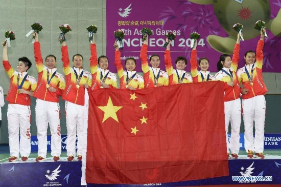 Athletes of China pose on the podium of the awarding ceremony of the women's team match of badminton event at the 17th Asian Games in Incheon, South Korea, Sept. 22, 2014. China defeated South Korea 3-0 and claimed the title.