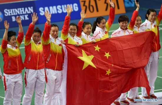 Athletes of China pose on the podium during the awarding ceremonoy of the women's team match of badminton event at the 17th Asian Games in Incheon, South Korea, Sept. 22, 2014. China defeated South Korea 3-0 and claimed the title.