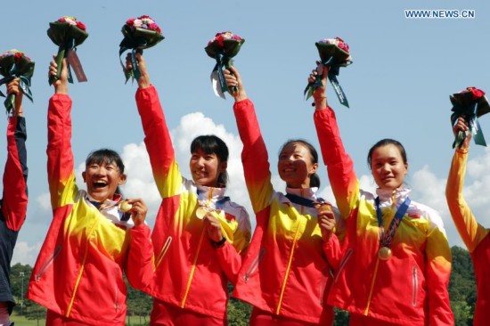 Zhang Xinyue, Wang Yuwei, Shen Xiaoxing and Wang Min (L to R) of China pose during the awarding ceremony of the women's quadruple sculls final of rowing at the 17th Asian Games in Chungju, South Korea, Sept. 25, 2014. China won the gold medal. 