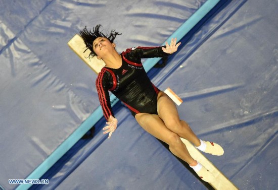 Egyptian gymnast Malak Zaghloul performs on the beam during the women's qualifying round of the 45th Gymnastics World Championships in Nanning, capital of south China's Guangxi Zhuang Autonomous Region, Oct. 5, 2014.