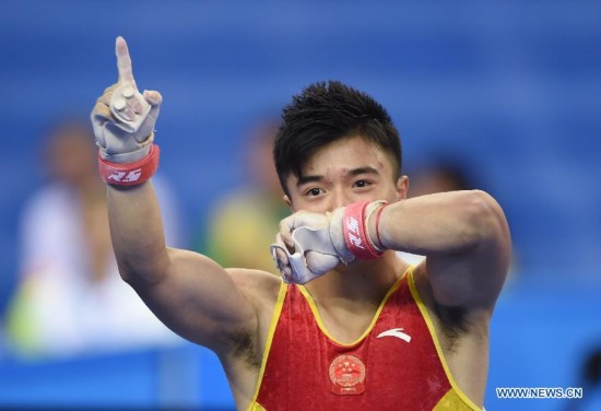 Chinese gymnast Liu Yang celebrates after his rings performance during the men's individual apparatus finals of the 45th Gymnastics World Championships in Nanning, capital of south China's Guangxi Zhuang Autonomous Region, Oct. 11, 2014. Liu Yang won the gold medal in the men's rings final with 15.933 points.