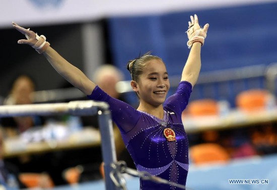 Chinese gymnast Yao Jinnan poses after her uneven bars performance during the women's individual apparatus finals of the 45th Gymnastics World Championships in Nanning, capital of south China's Guangxi Zhuang Autonomous Region, Oct. 11, 2014. Yao Jinnan won the gold medal in the women's uneven bars final with 15.633 points.