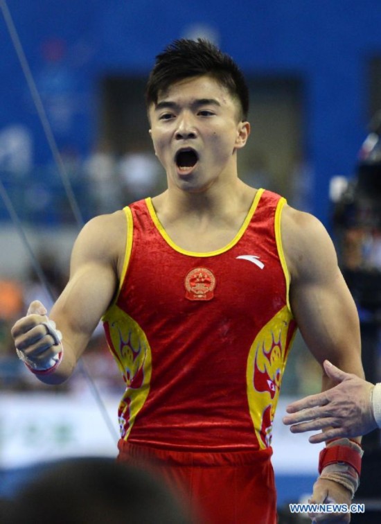 Chinese gymnast Liu Yang celebrates after his rings performance during the men's individual apparatus finals of the 45th Gymnastics World Championships in Nanning, capital of south China's Guangxi Zhuang Autonomous Region, Oct. 11, 2014.