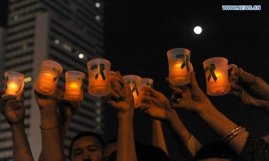 A woman holds a candle to commemorate the World Mental Health Day 2014 to raise awareness of schizophrenia and support mental health in Jakarta, Indonesia, Oct. 10, 2014.