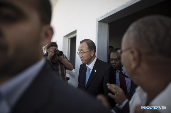 United Nations Secretary-General Ban Ki-Moon (C) is seen at Gaza City's harbor on October 14, 2014. 