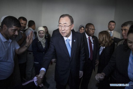 United Nations Secretary-General Ban Ki-Moon (C) shake hands with Palestinian fisherwoman Madeline Kolab (UNSEEN) at Gaza City's harbor on October 14, 2014.