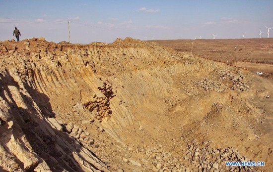 A man visits the basalt columns in Zhangbei County, north China's Hebei province, Oct. 19, 2014. A large amount of basalt columns was discovered here recently, which is considered to be formed in miocene times. (Xinhua/Yang Shiyao)