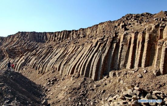 Visitors take photos of the basalt columns in Zhangbei County, north China's Hebei province, Oct. 19, 2014. A large amount of basalt columns was discovered here recently, which is considered to be formed in miocene times. (Xinhua/Yang Shiyao)