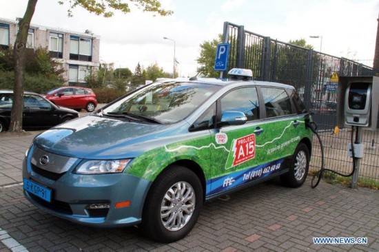 A BYD e6 Electric taxi made in China is in charging on a street in Rotterdam, the Netherlands, on Oct. 20, 2014. 