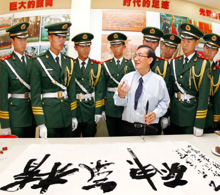中国国家画院院委、中国文联第九次代表、中国美术家协会第七届理事、中国书法家协会会员、著名艺术家徐嘉炀为国旗护卫队官兵题写书法作品《精气神》 中新社发 王保胜 摄