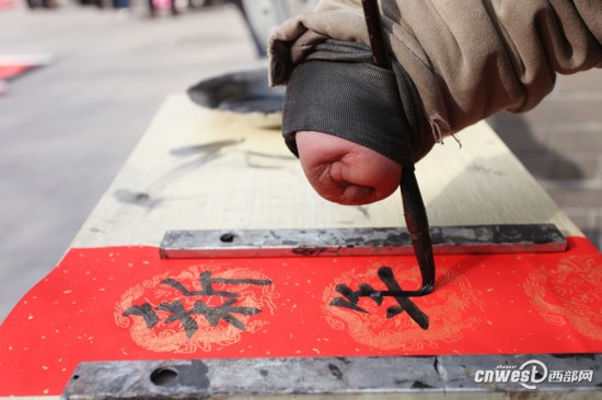 西安书院门一片红 无臂书法家断臂写春联