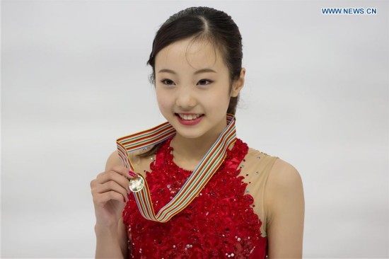Gold medalist Marin Honda of Japan attends the awards ceremony of women's figure skating during the ISU World Junior Figure Skating Championships in Debrecen, Hungary, March 19, 2016. 