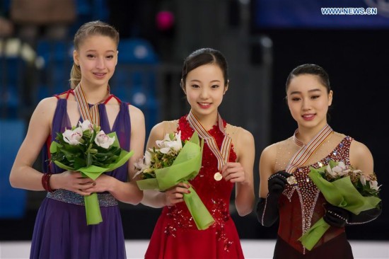 Gold medalist Marin Honda (C) of Japan, silver medalist Maria Sotskova (L) of Russia and bronze medalist Wakaba Higuchi of Japan attend the awards ceremony of women's figure skating during the ISU World Junior Figure Skating Championships in Debrecen, Hungary, March 19, 2016.