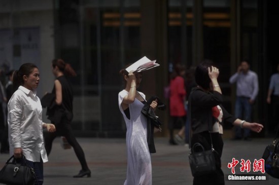 重庆高温直逼30℃ 街头市民穿凉装出行