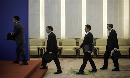 Chinese officials arrive for a press conference at the Great Hall of the People in Beijing, on Thursday. China’s top legislature passed a law providing new regulations on foreign NGOs. Photo: AFP