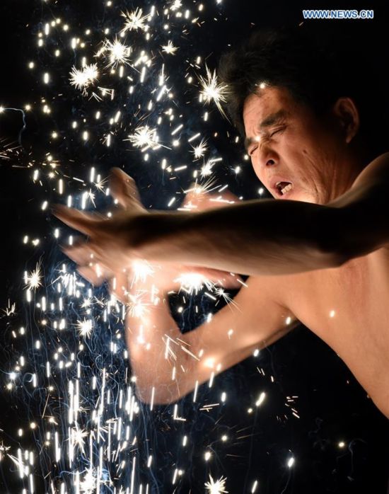 A villager performs 'firework eating' in Huadong Village, Putian City of southeast China's Fujian Province, Feb. 12, 2017.