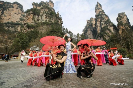Women present Qipao, or cheongsam, in Wulingyuan scenic area, a UNESCO world Heritage site in Zhangjiajie in central China's Hunan province, Feb. 25, 2017. 