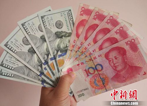 資料圖：人民幣和美元。中新網</a><p  align=