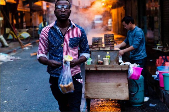 An African student buys breakfast at a stall in the “African Street