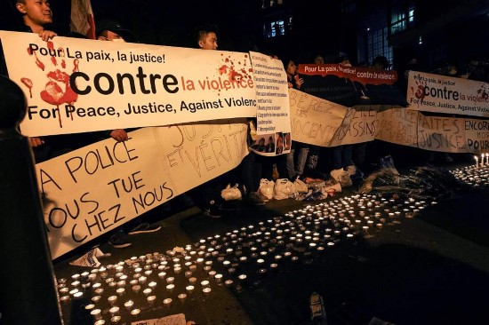 People hold a banner reading 