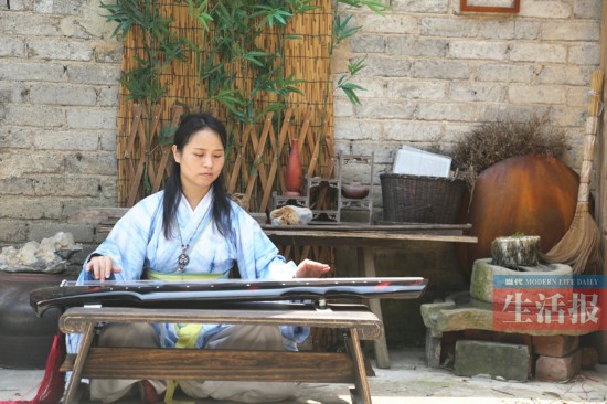 白天穿越回古代   身穿一袭汉服的轻柔女子,在古宅小院内品茶闻香弹琴