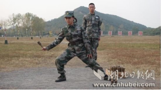 An undated photo shows a live-streaming hostess learning to properly throw a hand grenade during a live-streaming program at a military camp in Hubei Province. [File Photo: cnhubei.com]