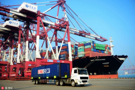 A truck transports a container to be shipped abroad at the Port of Qingdao, east China′s Shandong province, on July 13, 2017. [Photo: IC]