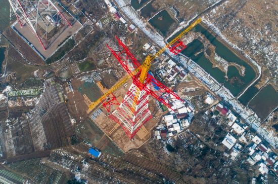 日,在安徽省繁昌县荻港镇,跨越塔在进行横担吊