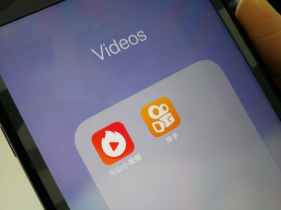 Icons of video apps Huoshan and Kuaishou on a mobile phone screen. [Photo: China Plus]