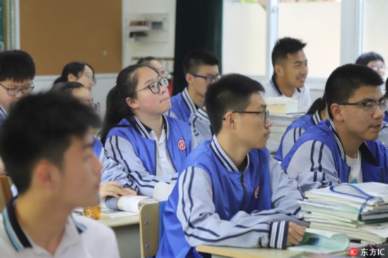 Students attend class in a classroom equipped with a facial-recognition camera at Hangzhou No. 11 High School, in Hangzhou, Zhejiang Province, on May 15, 2018. [Photo: IC]