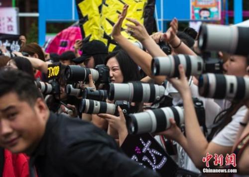 粉絲們在北京一個粉絲嘉年華上拍攝偶像。<a target='_blank'  data-cke-saved-href='http://www.chinanews.com/' href='http://www.chinanews.com/'><p  align=