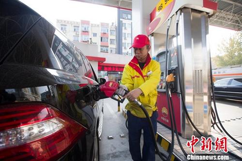 資料圖：加油站內，工作人員正在給車輛加油。<a target='_blank'  data-cke-saved-href='http://www.chinanews.com/' href='http://www.chinanews.com/'><p  align=