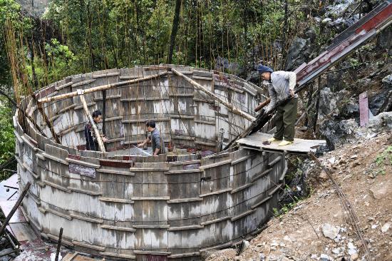 广西都安瑶族自治县隆福乡的村民在修建家庭水柜(2020年3月17日摄)。