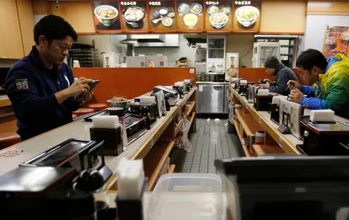 東京のある飲食店で食事をする男性たち（資料写真）。