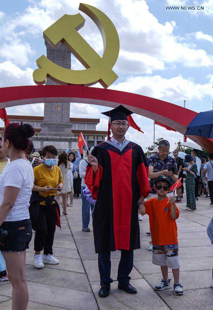 People take photos of ceremony decoration at Tian'anmen Square