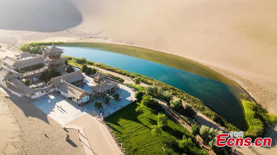 Plants by Crescent Lake turn greener after rain in Dunhuang