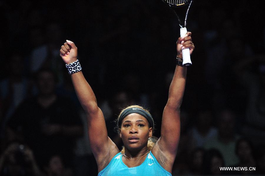 Serena Williams of the United States celebrates after winning the round robin match of the WTA Finals against Serbia's Ana Ivanovic at the Singapore Indoor Stadium, Oct. 20, 2014. Serena Williams won 2 to 0. (Xinhua/Then Chih Wey) 