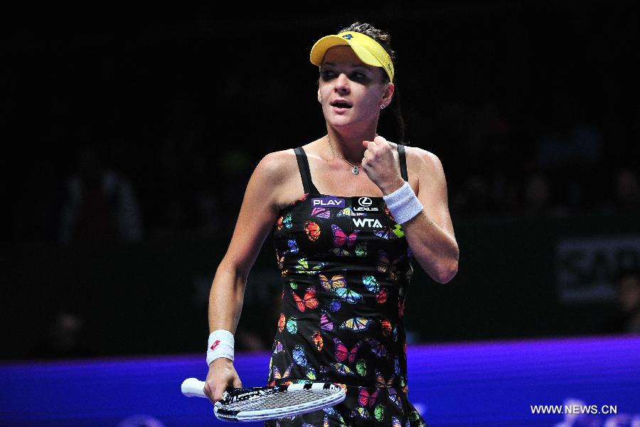 Poland's Agnieszka Radwanska celebrates during the WTA Finals singles tennis match against the Czech Republic's Petra Kvitova at the Singapore Indoor Stadium, Oct. 21, 2014.