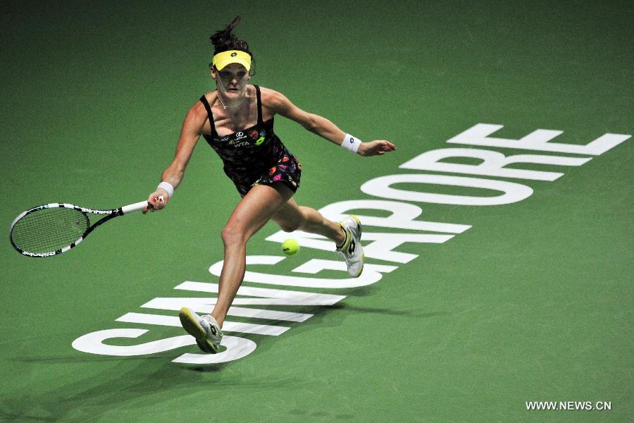 Poland's Agnieszka Radwanska returns the ball during the WTA Finals singles tennis match against the Czech Republic's Petra Kvitova at the Singapore Indoor Stadium, Oct. 21, 2014. 