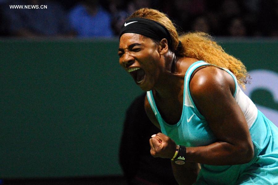 Serena Williams of the U.S. celebrates during the round robin match of the WTA Finals against Canada's Eugenie Bouchard at the Singapore Indoor Stadium, Oct. 23, 2014. Serena Williams won 2-0. (Xinhua/Then Chih Wey) 