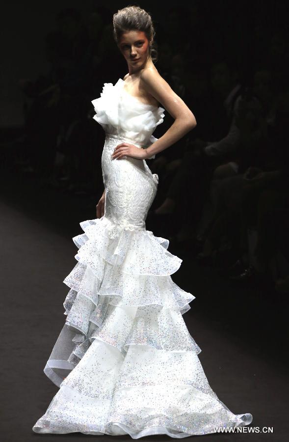 A model presents a wedding gown designed by Peng Jing during China Fashion Week in Beijing, capital of China, Oct. 26, 2014.