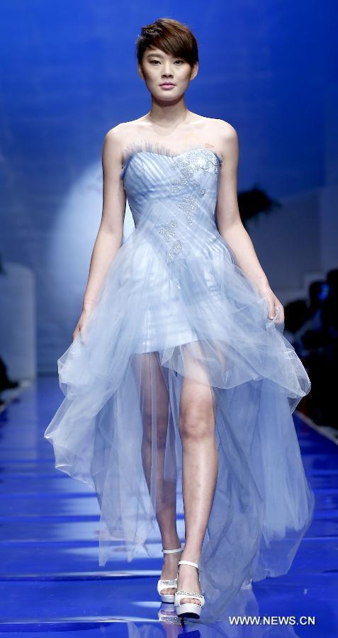 A model presents a wedding gown designed by Ren Chunhua during China Fashion Week in Beijing, capital of China, Oct. 26, 2014. 